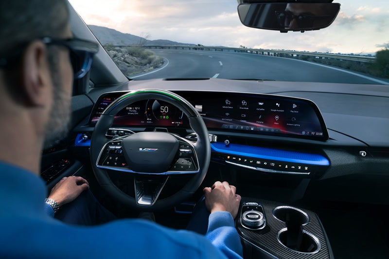 Front View of the 2026 OPTIQ-V Driving Through the Dusk Utilizing its Headlights | Ed Morse Cadillac Brandon FL in Brandon FL