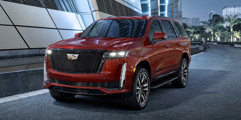 Red car running on road beside building